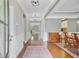 Grand foyer featuring hardwood floors, elegant lighting, and classic wainscoting leading to the dining area at 206 President Cir, Summerville, SC 29483