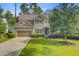 Charming two-story home features a two-car garage, well-kept lawn, and thoughtfully designed landscaping at 206 President Cir, Summerville, SC 29483