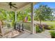 Inviting front porch view with seating, a ceiling fan, and a view of the landscaped front yard at 206 President Cir, Summerville, SC 29483