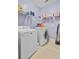 Functional laundry room with appliances, tile flooring and shelves for storage at 206 President Cir, Summerville, SC 29483