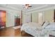 Bright main bedroom with hardwood floors, tray ceiling and a decorative bed frame at 206 President Cir, Summerville, SC 29483