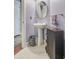 Stylish powder room featuring a pedestal sink, decorative mirror, and storage cabinet at 206 President Cir, Summerville, SC 29483