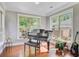 Sun-drenched sun room featuring large windows and gleaming hardwood floors at 206 President Cir, Summerville, SC 29483