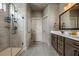 Well-lit bathroom featuring a sleek glass-enclosed shower, double vanity, and modern fixtures at 2234 Kemmerlin St, Johns Island, SC 29455