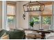 Elegant dining area with rustic wood table, bench seating, and modern chandelier at 2234 Kemmerlin St, Johns Island, SC 29455