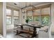 Elegant dining room with natural light, a rustic table, and seating for eight at 2234 Kemmerlin St, Johns Island, SC 29455