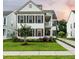 Attractive two-story home with a covered porch, large windows, and lush green lawn at 2234 Kemmerlin St, Johns Island, SC 29455