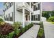 Charming two-story home with a welcoming front porch, red door, black shutters, and well-manicured landscaping at 2234 Kemmerlin St, Johns Island, SC 29455