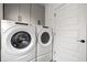 Functional laundry area with gray cabinets and modern Whirlpool washer and dryer at 2234 Kemmerlin St, Johns Island, SC 29455
