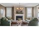 Comfortable living room featuring a fireplace, elegant chandelier, and cozy seating arrangement at 2234 Kemmerlin St, Johns Island, SC 29455