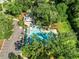 Aerial view of a community pool with a pavilion and lounge chairs surrounded by mature trees and a parking lot at 2234 Kemmerlin St, Johns Island, SC 29455