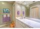 Bright bathroom featuring a long vanity, ample cabinet storage, and a shower at 2287 Shoreline Dr, Johns Island, SC 29455