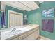 Bright bathroom featuring white vanity, framed mirror, and tub with shower, offering a serene space at 2287 Shoreline Dr, Johns Island, SC 29455