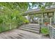Back deck with stairs, railing, and plenty of room to relax and enjoy the natural landscaping at 2287 Shoreline Dr, Johns Island, SC 29455