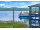 A charming dock featuring a covered boat and a playful dolphin swimming nearby at 2287 Shoreline Dr, Johns Island, SC 29455
