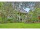 Exterior view of the home surrounded by lush landscaping, showcasing its unique architectural details at 2287 Shoreline Dr, Johns Island, SC 29455