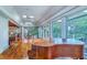 Open-concept living area with hardwood floors, multiple windows, skylights, and a grand piano at 2287 Shoreline Dr, Johns Island, SC 29455