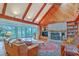 Cozy living room with vaulted ceilings, exposed beams, fireplace and seamless access to an outdoor area at 2287 Shoreline Dr, Johns Island, SC 29455