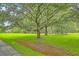 Expansive yard with large trees and a view of the house in the background at 2287 Shoreline Dr, Johns Island, SC 29455