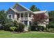 Charming two-story home with well-manicured lawn and lush landscaping, including a covered porch with stairs at 2517 Charter Oaks Dr, Mount Pleasant, SC 29466