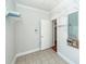 Functional laundry room with tiled floor, storage shelves, and essential utility connections at 2517 Charter Oaks Dr, Mount Pleasant, SC 29466
