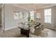 Elegant dining room with a glass-top table, chandelier, and modern decor at 2703 Grange Cir, Summerville, SC 29486