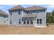 A view of the back exterior of the home, showcasing its many windows and siding at 2807 Grange Cir, Summerville, SC 29486