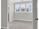 Bedroom with three large windows for natural light and neutral carpeting at 2807 Grange Cir, Summerville, SC 29486