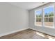 Bright bedroom with wood floors, white trim, and a large window with outdoor views at 2807 Grange Cir, Summerville, SC 29486