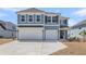 Two-story home with a three-car garage and a well-maintained front yard at 2807 Grange Cir, Summerville, SC 29486