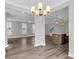 Open concept living and dining space with modern lighting, hardwood floors, and kitchen island at 2807 Grange Cir, Summerville, SC 29486