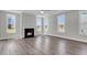 Bright living room featuring a fireplace, large windows, and hardwood floors at 2807 Grange Cir, Summerville, SC 29486