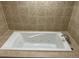 Luxurious white bathtub featuring jacuzzi jets and tile surround, perfect for relaxation at 2827 Haverhill Cir, North Charleston, SC 29420