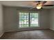 Cozy bedroom with a large window, ceiling fan, and neutral carpet creating a comfortable retreat at 2827 Haverhill Cir, North Charleston, SC 29420
