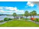 Expansive backyard featuring a private dock, lush lawn, and serene waterfront views from an elevated vantage point at 307 Morning Marsh Ln, Charleston, SC 29492