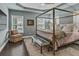 Serene bedroom with a four-poster bed, tray ceiling, and lots of natural light at 307 Morning Marsh Ln, Charleston, SC 29492