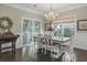 Elegant dining room with chandelier, slider to patio, and large window at 307 Morning Marsh Ln, Charleston, SC 29492