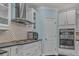 Modern kitchen with stainless steel appliances, including a gas range and double ovens, with tile backsplash at 307 Morning Marsh Ln, Charleston, SC 29492