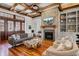 Comfortable living room featuring a brick fireplace, beamed ceilings, and stylish furnishings for relaxing or entertaining at 307 Morning Marsh Ln, Charleston, SC 29492