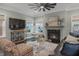 Inviting living room boasts a fireplace, stylish furniture, and a hanging chair for relaxation at 307 Morning Marsh Ln, Charleston, SC 29492
