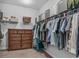 Spacious walk-in closet with custom shelving, clothing rods and dresser at 307 Morning Marsh Ln, Charleston, SC 29492