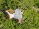 Aerial view of a grey roofed home nestled among lush trees with a winding driveway at 3125 Privateer Creek Rd, Seabrook Island, SC 29455