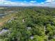 Aerial view of a home surrounded by lush trees, overlooking a scenic marsh and waterway at 3125 Privateer Creek Rd, Seabrook Island, SC 29455