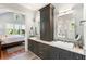 Elegant bathroom featuring double sinks, custom cabinetry, and a view into the main bedroom at 3125 Privateer Creek Rd, Seabrook Island, SC 29455