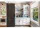 Bright butler's pantry with ample storage space, white cabinets, and natural light from the window at 3125 Privateer Creek Rd, Seabrook Island, SC 29455