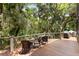 Inviting deck with outdoor seating and grill, surrounded by lush trees, perfect for entertaining and relaxing at 3125 Privateer Creek Rd, Seabrook Island, SC 29455