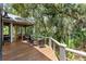 View of the deck with outdoor seating surrounded by beautiful lush green trees at 3125 Privateer Creek Rd, Seabrook Island, SC 29455