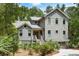 Charming two-story home with a landscaped yard and staircase leading to the front door at 3125 Privateer Creek Rd, Seabrook Island, SC 29455