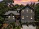 Charming two-story home with a grey exterior, a metal roof, and a well-manicured lawn at 3125 Privateer Creek Rd, Seabrook Island, SC 29455