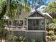 Back of the house featuring a wooden deck and screened-in porch surrounded by lush greenery at 3125 Privateer Creek Rd, Seabrook Island, SC 29455